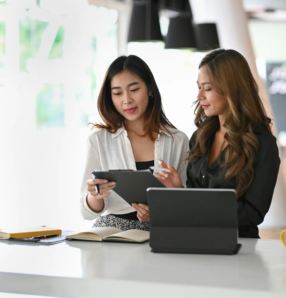 Two merchants reviewing pricing options together